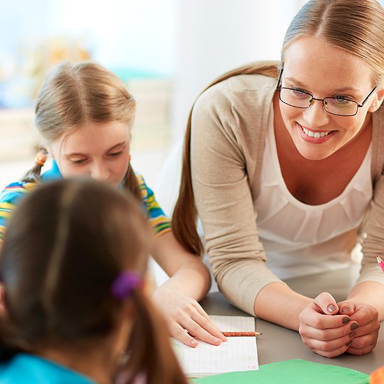 Dedicated teacher guiding young learners through creative reading and discovery