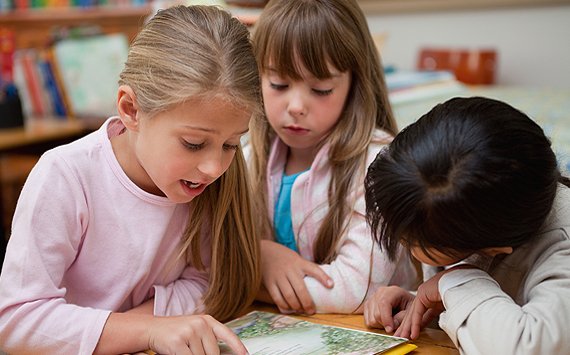 Children reading together during classroom early literacy time